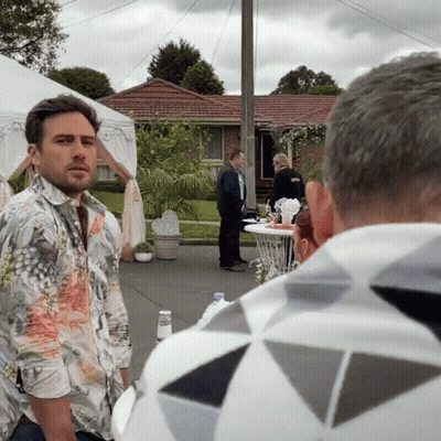 Man In Floral Shirt In Front Of House GIF