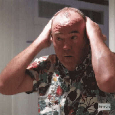 Man In Floral Shirt Looking In Mirror GIF