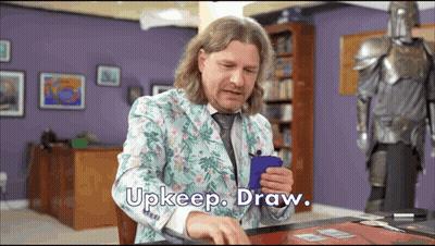 Man In Floral Suit Holding Blue Card Says Upkeep Draw GIF
