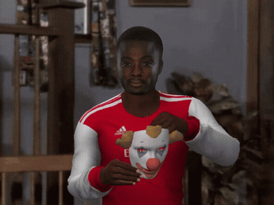 Man In Fly Emirates Jersey Holding Clown Mask Over Face GIF
