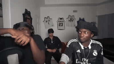 Man In Fly Emirates Jersey Talking To Another Man GIF