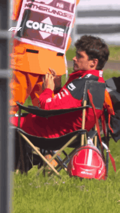 Man In Folding Chair With Course Sign GIF