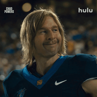 Man In Football Uniform Smiling In Front Of Hulu Ad GIF