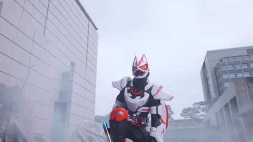 Man In Fox Costume In Front Of Brick Building GIF