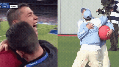 Man In France Lanyard Hugging Another On Soccer Field GIF