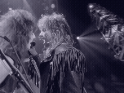 Man In Fringed Leather Jacket Singing Into Microphone GIF