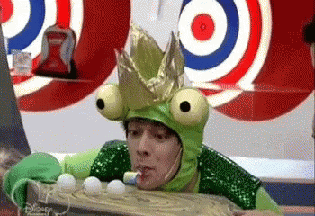 Man In Frog Costume And Crown Playing Game GIF