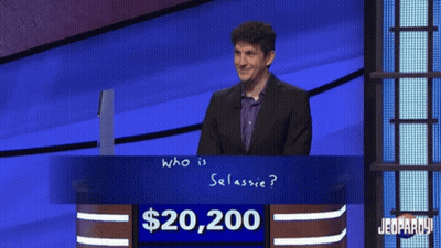 Man In Front Of $20,200 Jeopardy Sign GIF