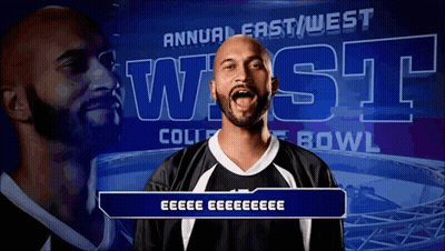 Man In Front Of Annual East West College Bowl Banner GIF