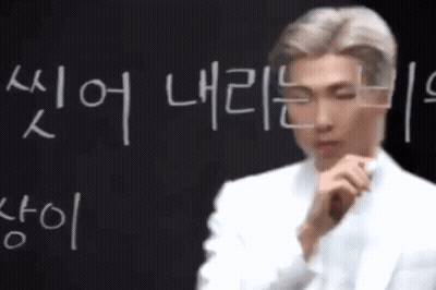 Man In Front Of Blackboard With Korean Writing GIF