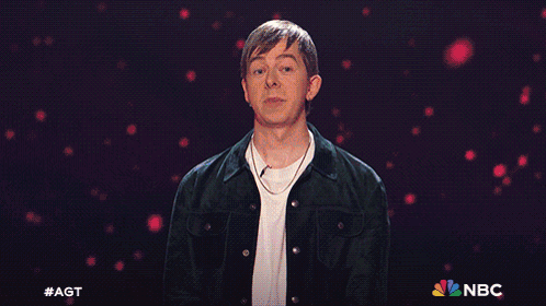Man In Front Of Blue Background With NBC Logo GIF