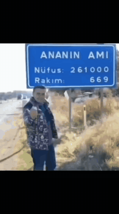 Man In Front Of Blue Sign Saying Ananin Ami GIF