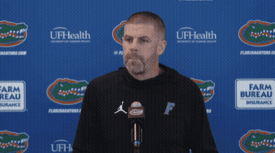 Man In Front Of Blue Wall Saying UFHealth GIF