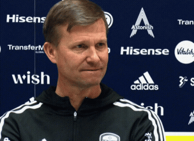 Man In Front Of Blue Wall With Hisense And Adidas Logos GIF