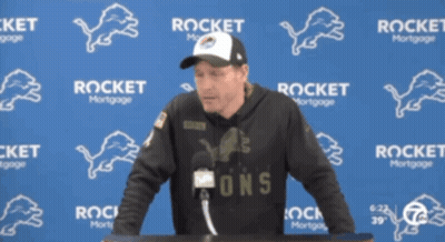 Man In Front Of Blue Wall With Rocket Mortgage GIF
