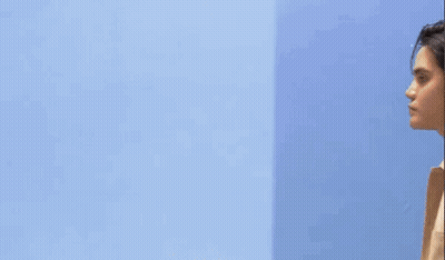Man In Front Of Blue Wall With Yellow Pablo GIF