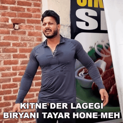 Man In Front Of Brick Wall Kitne Der Lagegi Biryani Tayar Hone Meh GIF