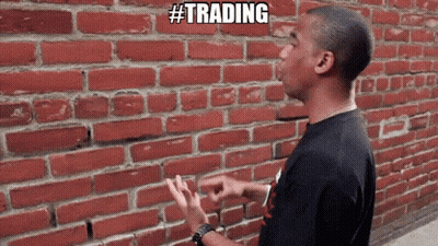 Man In Front Of Brick Wall Saying Trading GIF