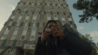 Man In Front Of Building With Peace GIF