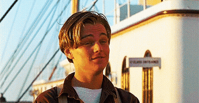 Man In Front Of Building With Titanic Sign GIF