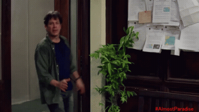 Man In Front Of Bulletin Board Saying Almost Paradise GIF