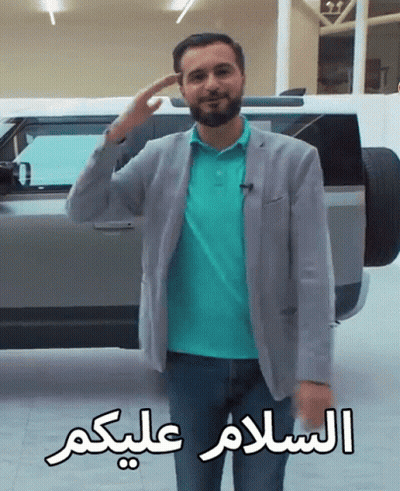 Man In Front Of Car With Arabic Writing GIF