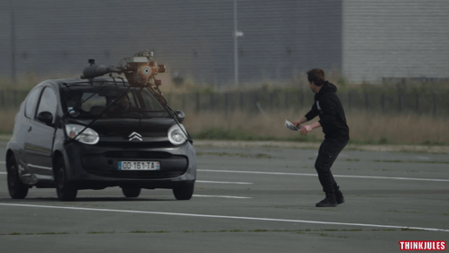 Man In Front Of Car With License Plate DD 161 TA GIF