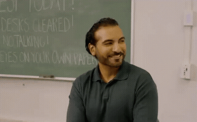 Man In Front Of Chalkboard Saying Desks Cleared GIF