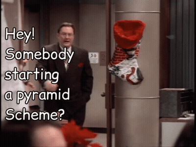 Man In Front Of Christmas Stocking Saying Hey Somebody Starting A Pyramid Scheme GIF