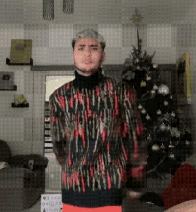 Man In Front Of Christmas Tree Wearing Sweater GIF