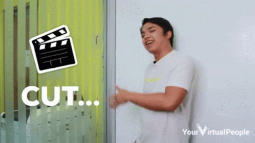 Man In Front Of Clapper Board Cut GIF