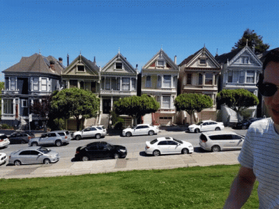 Man In Front Of Colorful Houses GIF