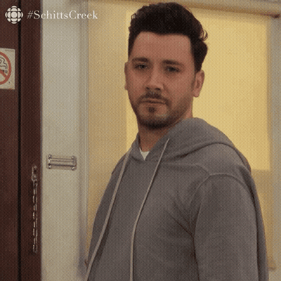 Man In Front Of Door With No Smoking Sign GIF
