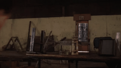 Man In Front Of Fire Exit Sign GIF