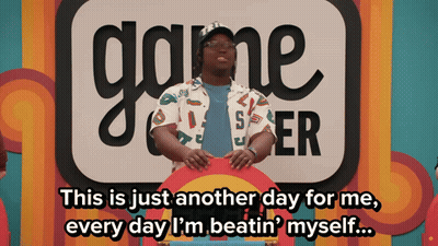 Man In Front Of Game Center Sign GIF