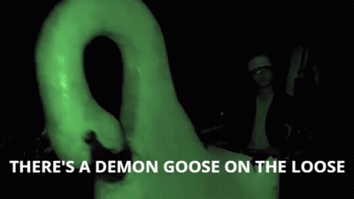 Man In Front Of Giant Goose Saying There's A Demon Goose On The Loose GIF