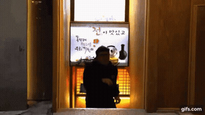 Man In Front Of Gifs.Com Sign GIF