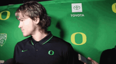Man In Front Of Green Toyota Sign GIF
