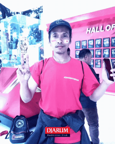 Man In Front Of Hall Of Fame Wall GIF