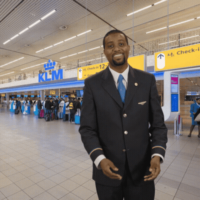 Man In Front Of KLM Sign GIF
