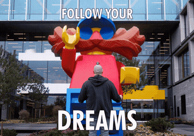 Man In Front Of Large Lego Statue Follow Your Dreams GIF