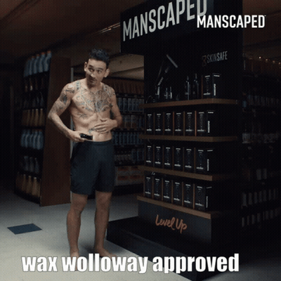 Man In Front Of Manscaped Sign GIF