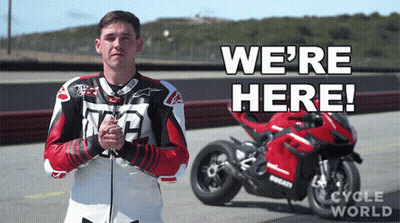 Man In Front Of Motorcycle Saying We're Here GIF