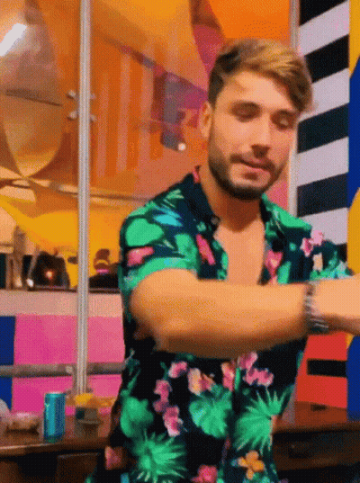 Man In Front Of Olympic Sign GIF