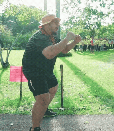 Man In Front Of Pink Army Sign GIF