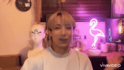Man In Front Of Pink Flamingo Neon Sign And Mannequin Head GIF