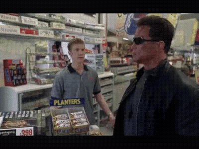 Man In Front Of Planters Candy Display GIF