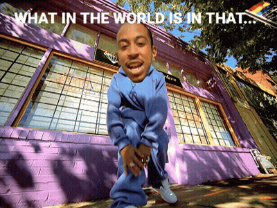 Man In Front Of Purple Building Saying What In The World Is In That GIF
