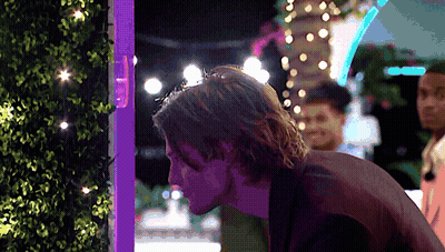 Man In Front Of Purple Light Looking Down GIF