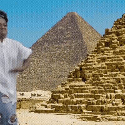 Man In Front Of Pyramid In Desert GIF